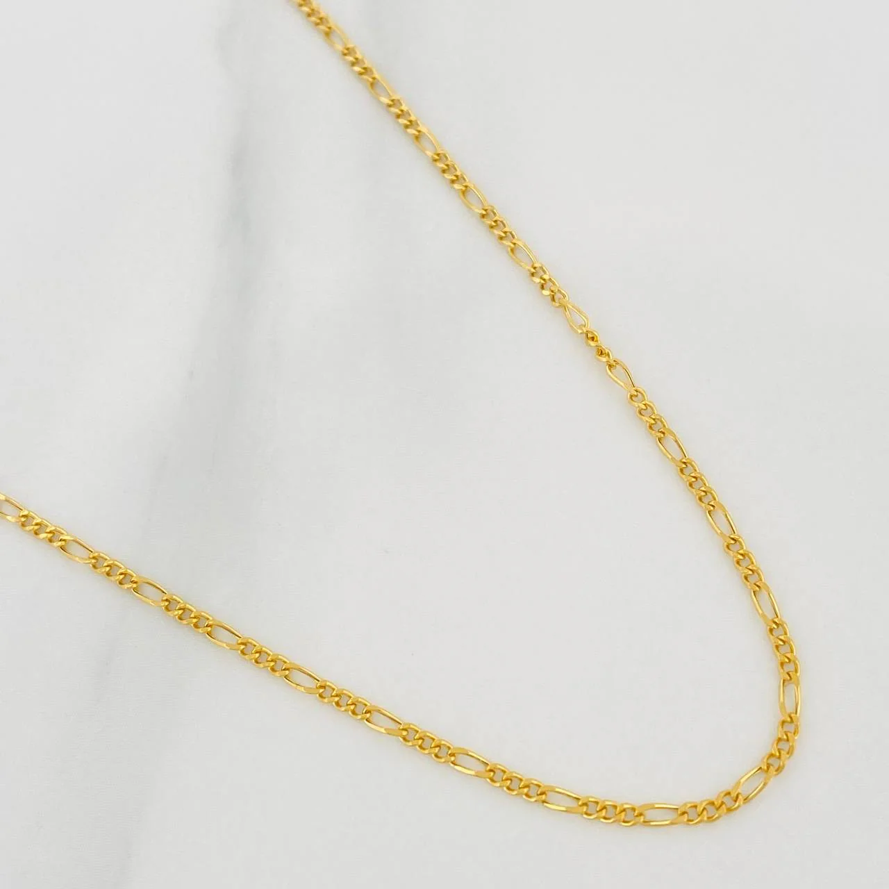 Cadena Figaro 1.8gr / 60cm / 1.55mm Oro Amarillo +1 18K $