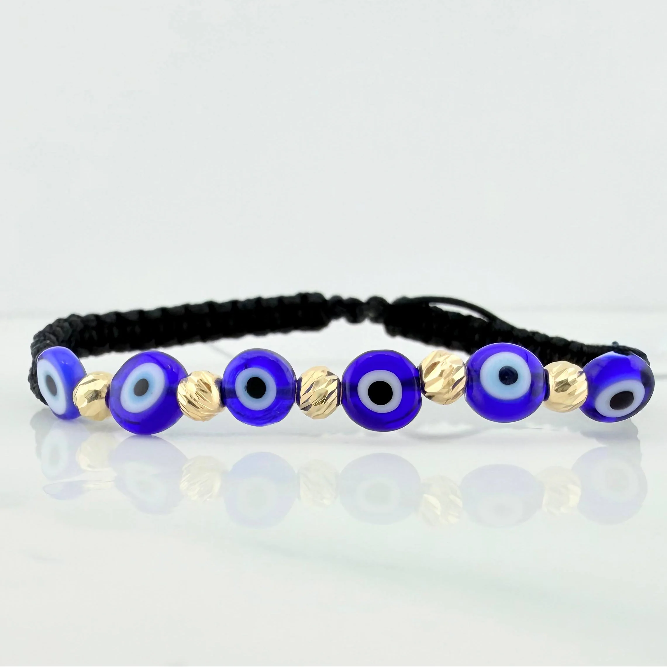 Pulsera Tejida Negra Ojos Turcos Azules Oro Amarillo 18K