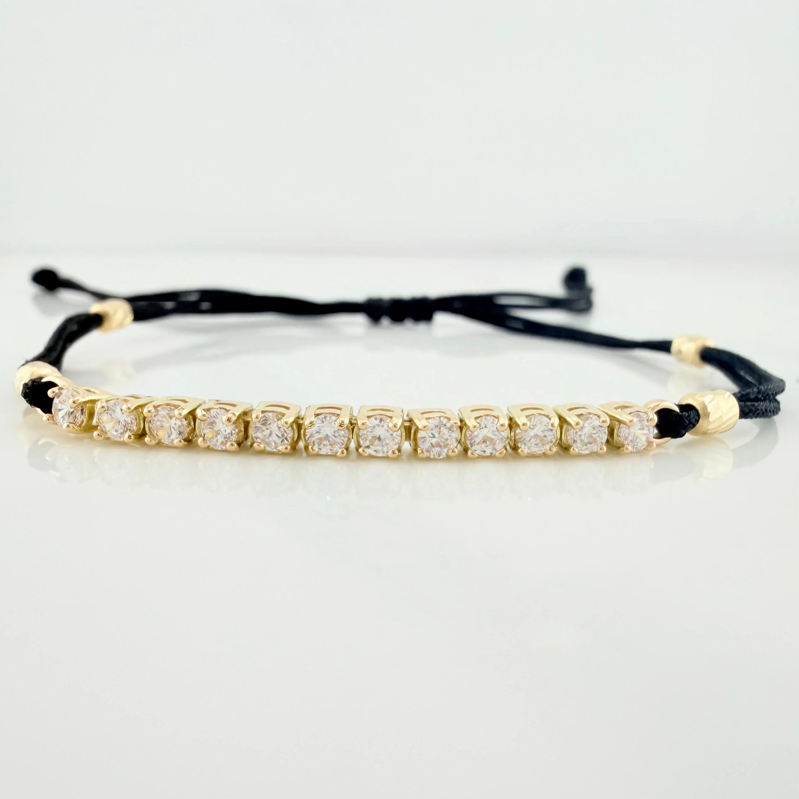 Pulsera Tejida Negra Retazo Tennis Oro Amarillo 18K